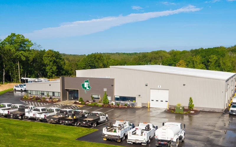 Aerial view of Fairfield Landscaping and Tree Services offices and workshop with their fleet of vehicles parked out front